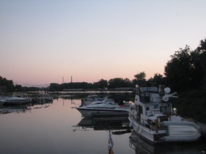 The marina at sunset and a barge on the river.